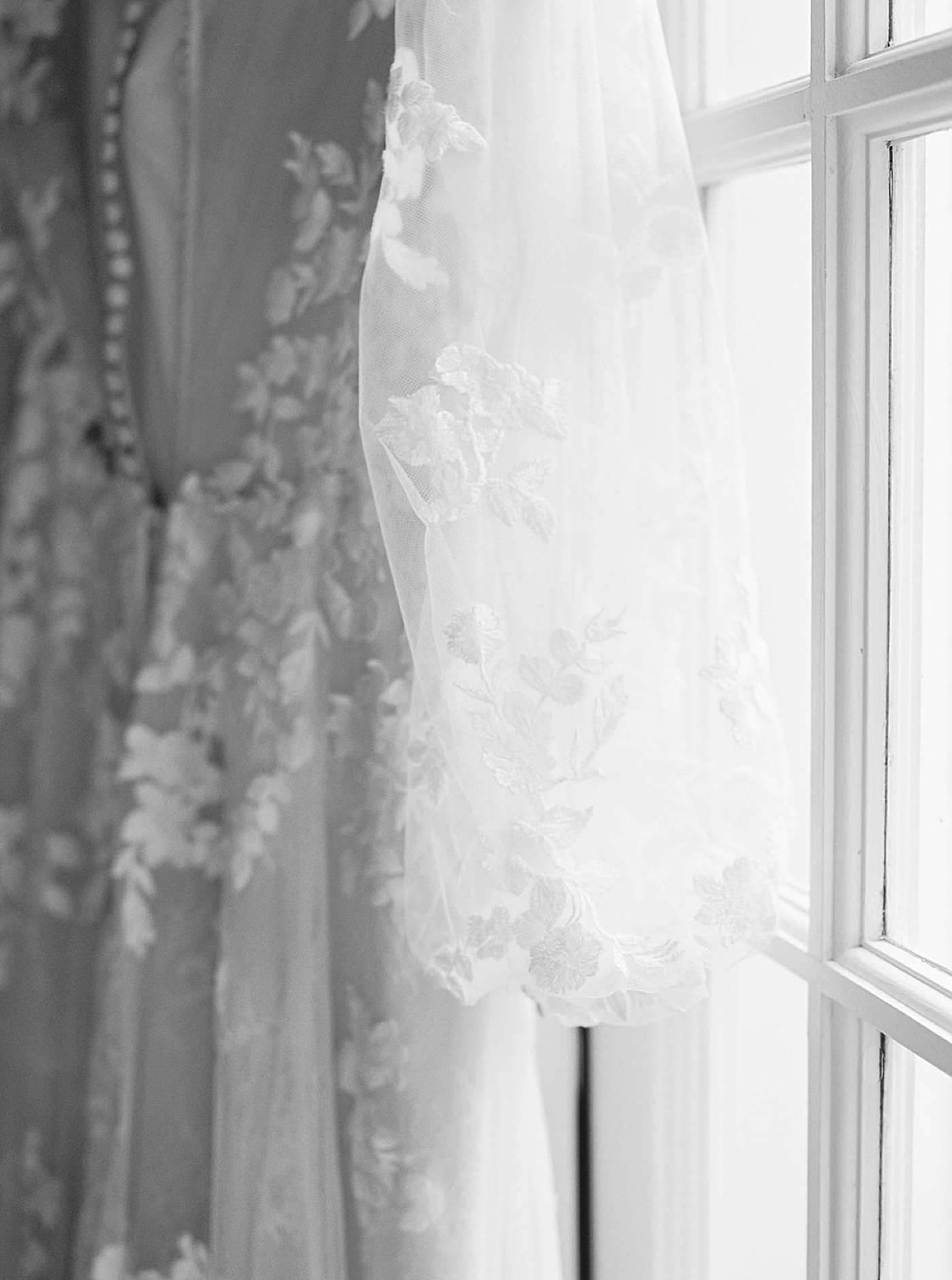 Black and white image of bridal gown in a window | Carters Event Co