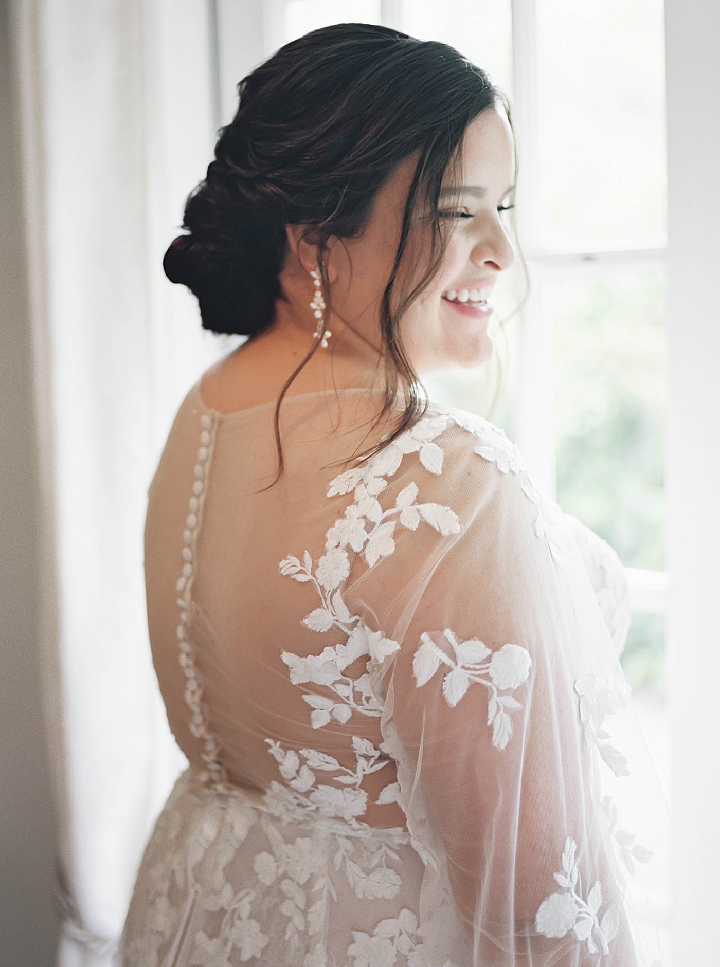 Bride in a lace gown near a window | Carters Event Co