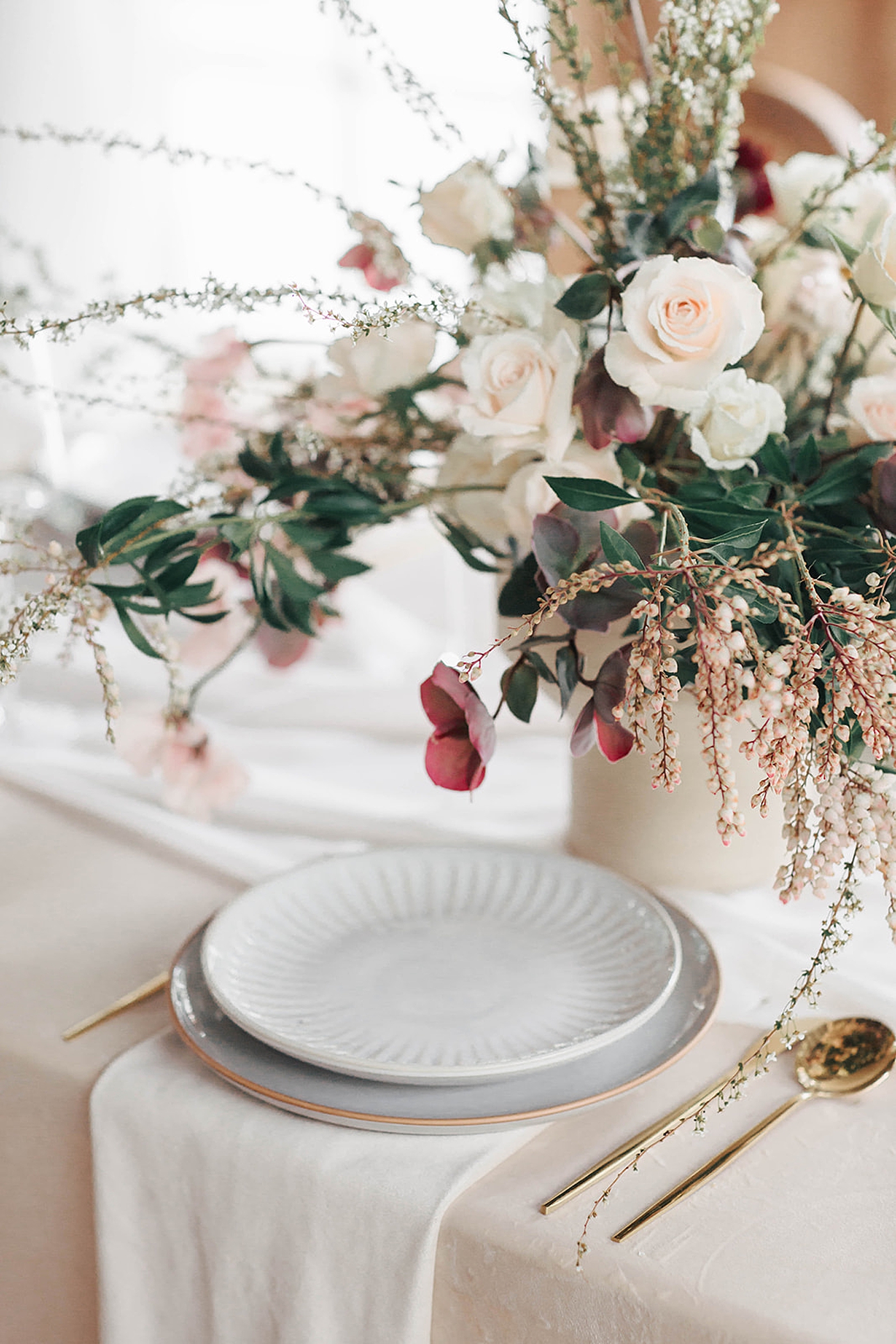 Table setting with pink and cream flowers in a table | Carters Event Co