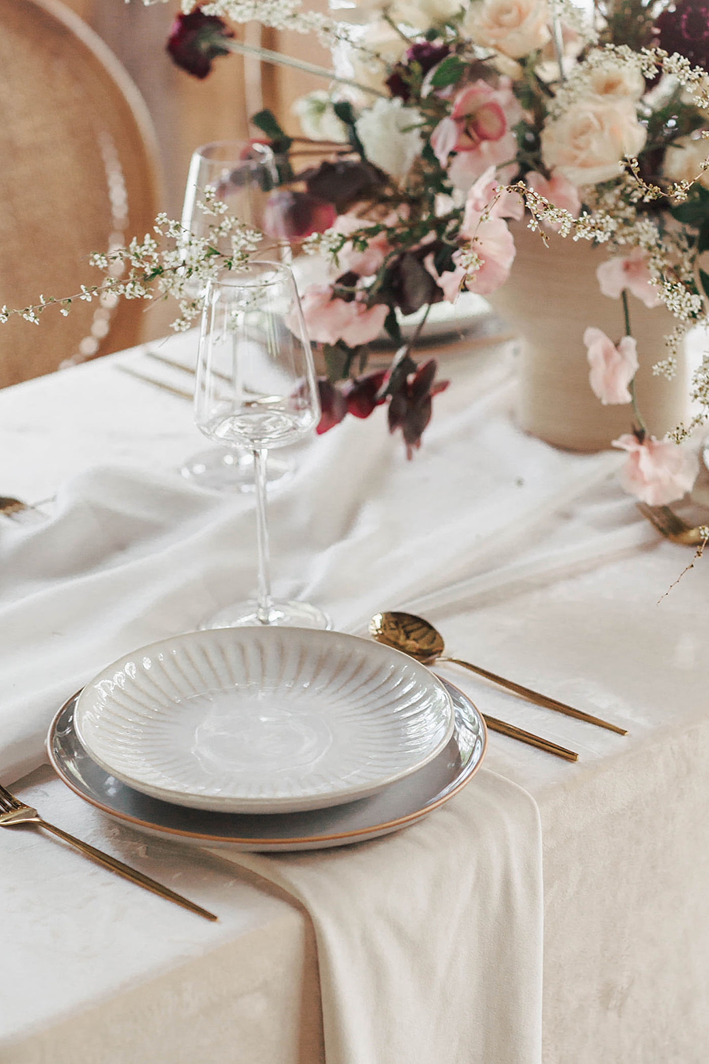 Table setting with florals in the background | Romantic French Countryside Editorial by Carters Event Co