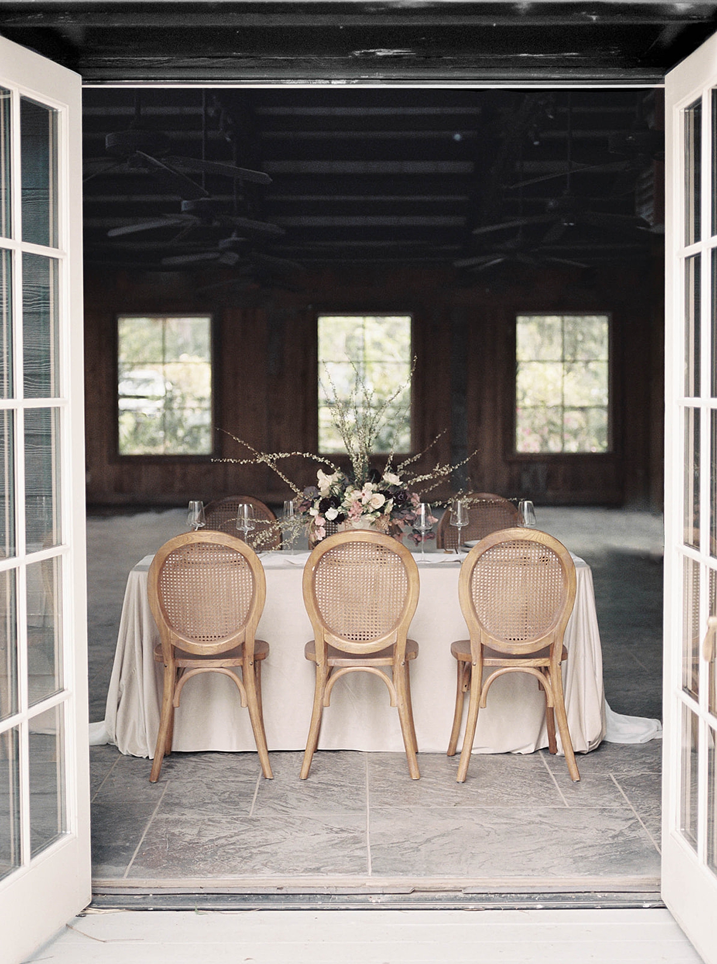 Wedding table through a doorway | Romantic French Countryside Editorial by Carters Event Co