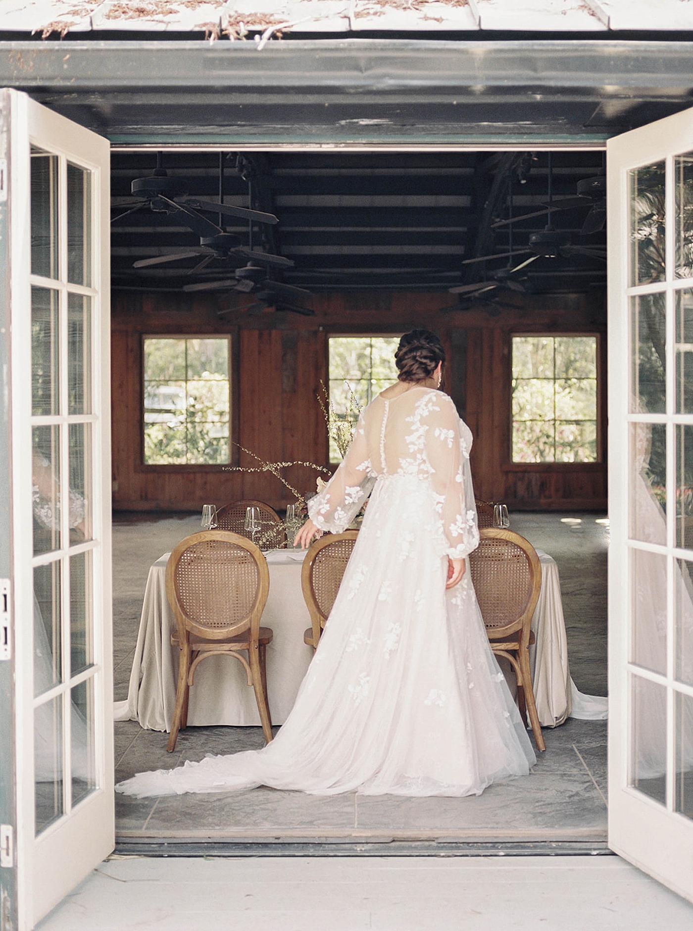 Bride walking by a table at her reception | Carters Event Co