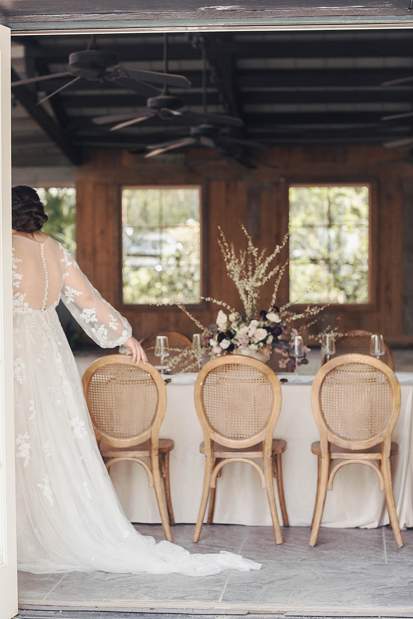 Bride walking by a table at her reception | Romantic French Countryside Editorial by Carters Event Co
