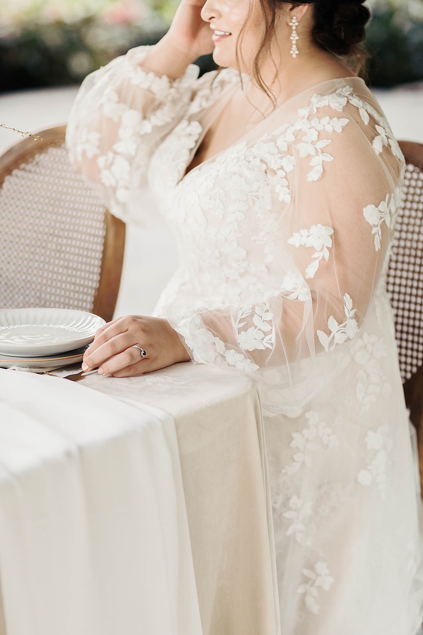 Bride in a lace gown sitting at a table | Romantic French Countryside Editorial by Carters Event Co