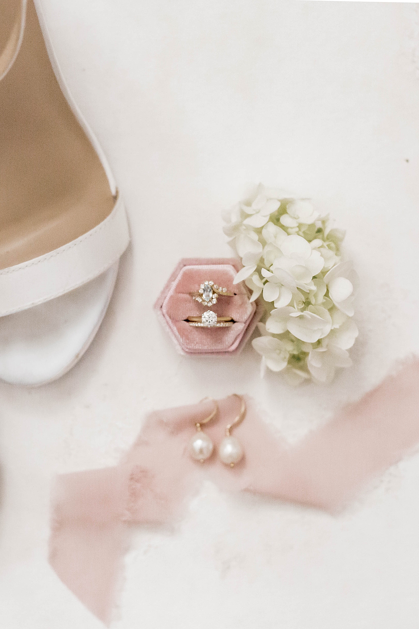 Wedding rings in a pink ring box with pearl earrings | Carters Event Co