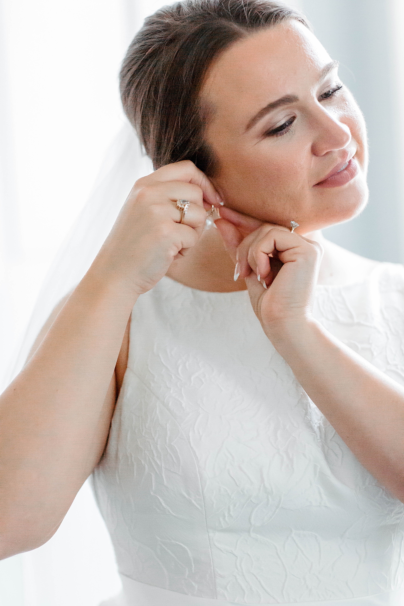 Bride putting in her earrings | Carters Event Co
