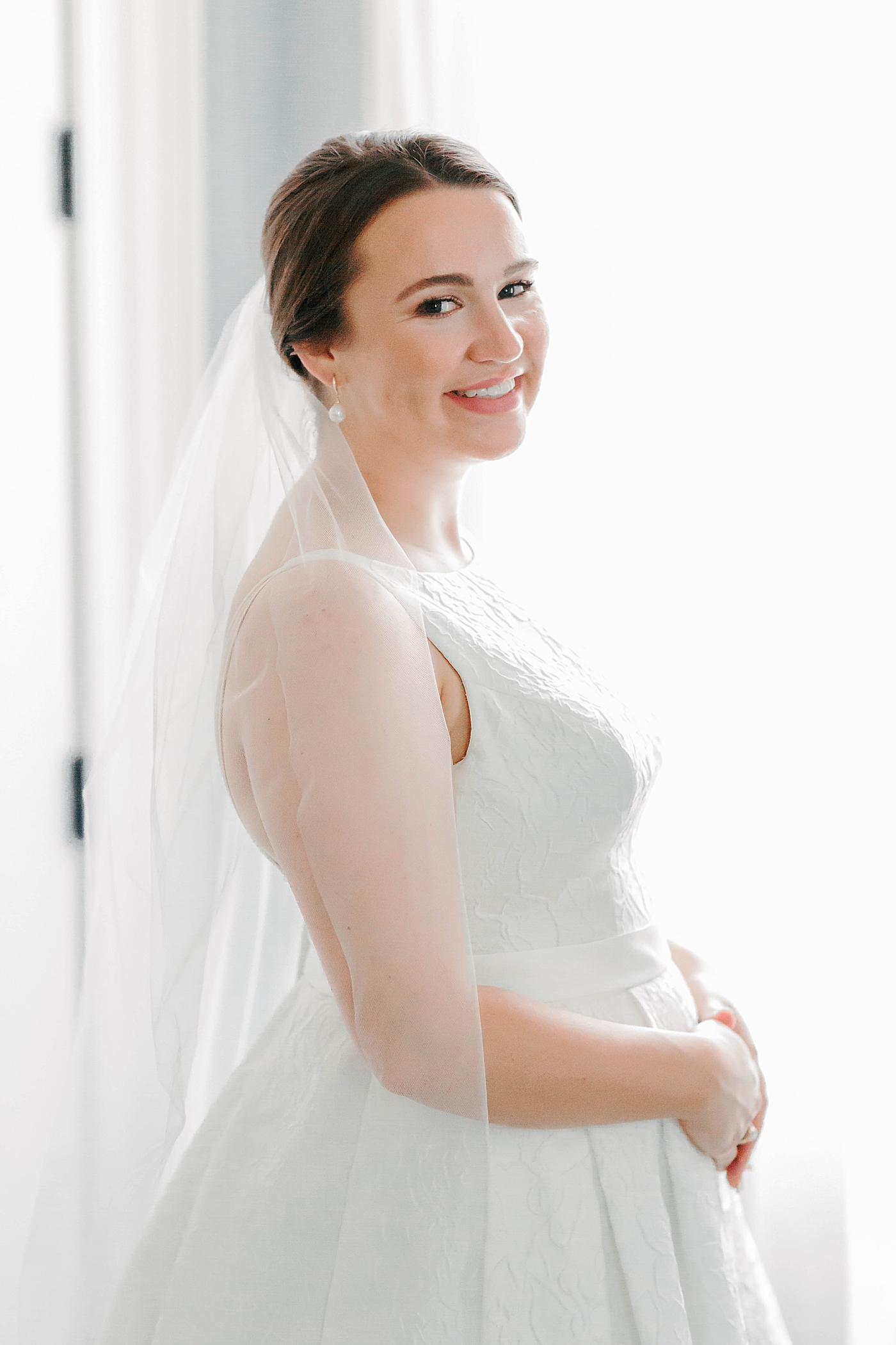 Bride smiling near a window | Carters Event Co