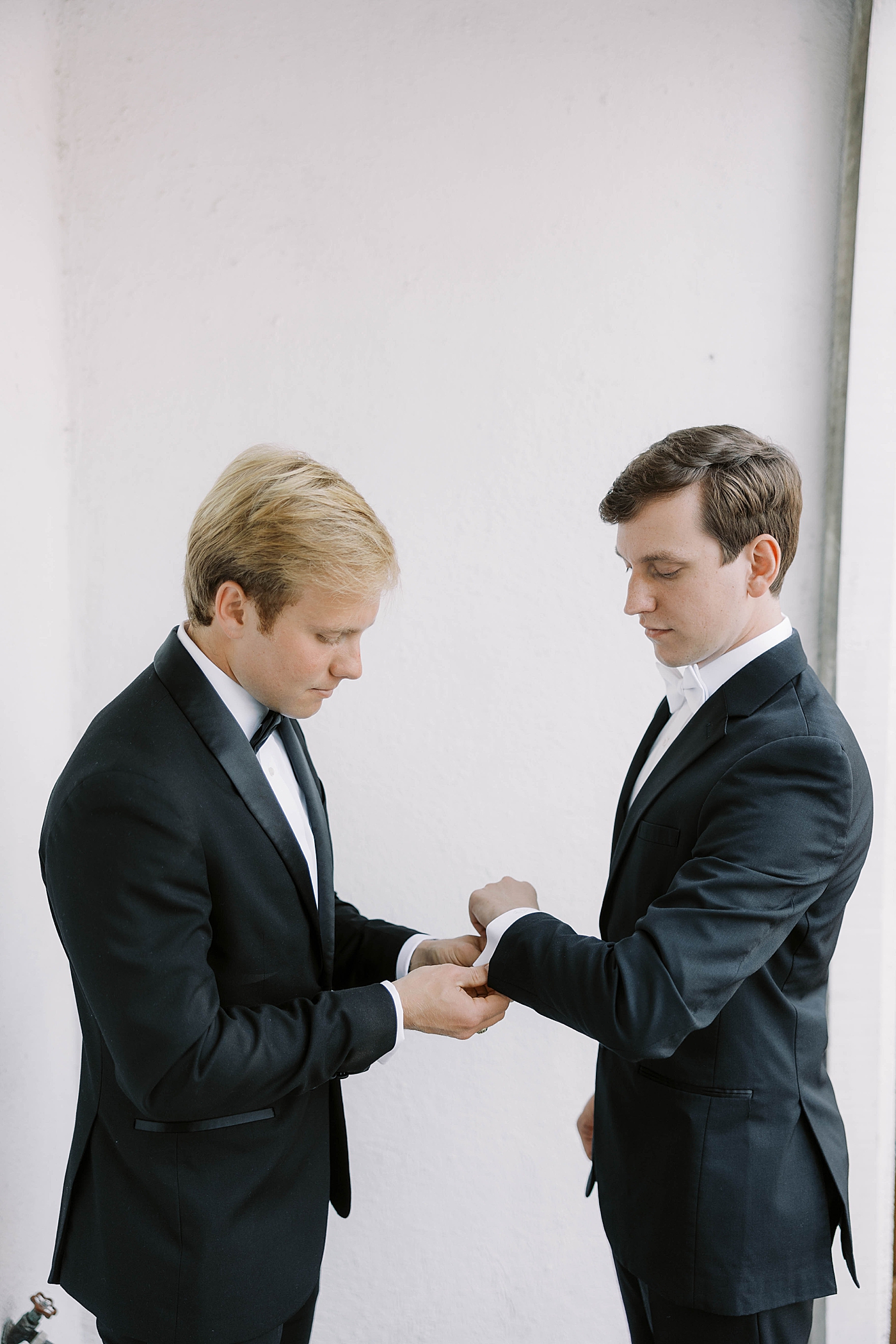 Groom being helped with his cufflinks | Carters Event Co