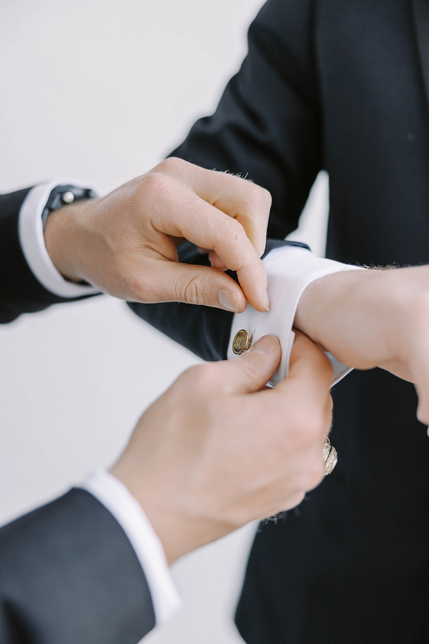 Detail of groom being helped with his cufflinks | Carters Event Co