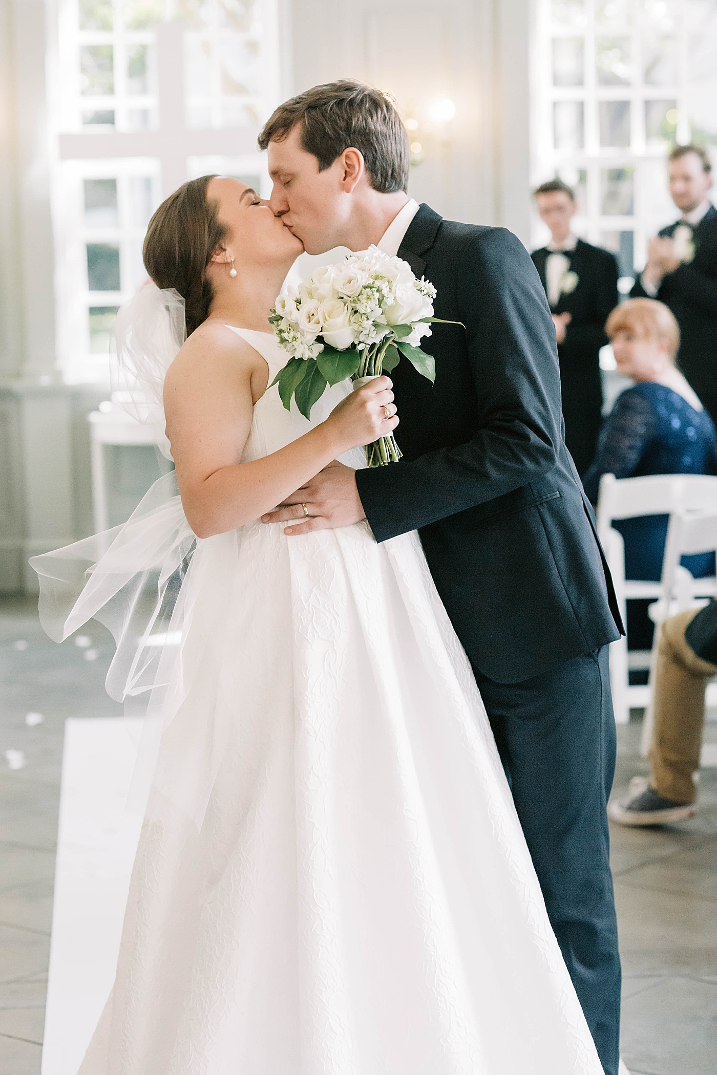 Bride and groom kiss walking down the aisle | Carters Event Co