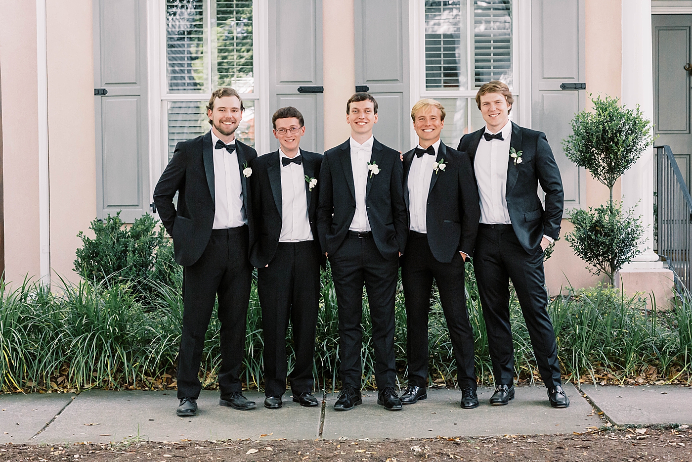 Groom posing with groomsmen | Carters Event Co