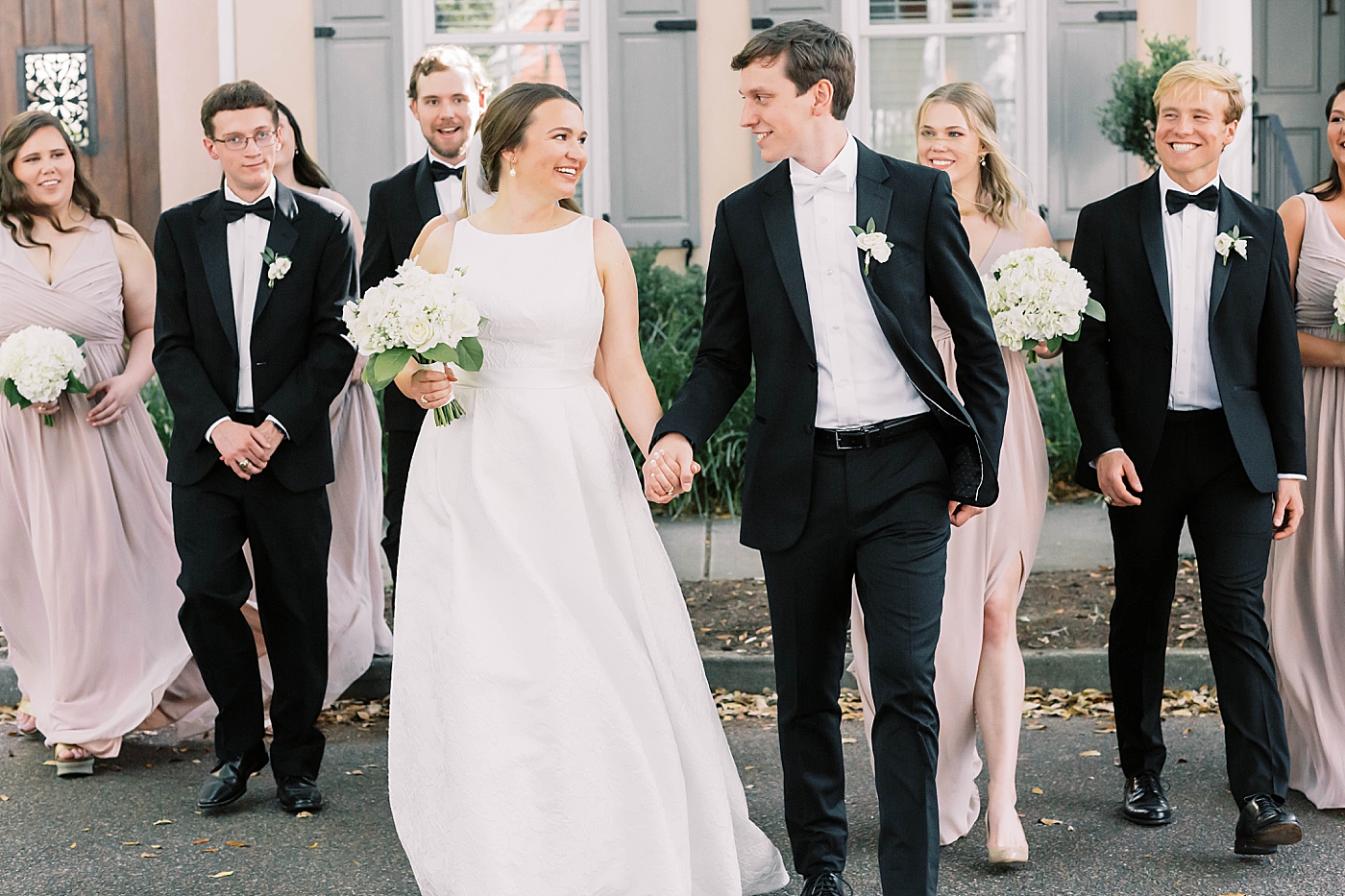 Bride and groom walking with their wedding party | Carters Event Co
