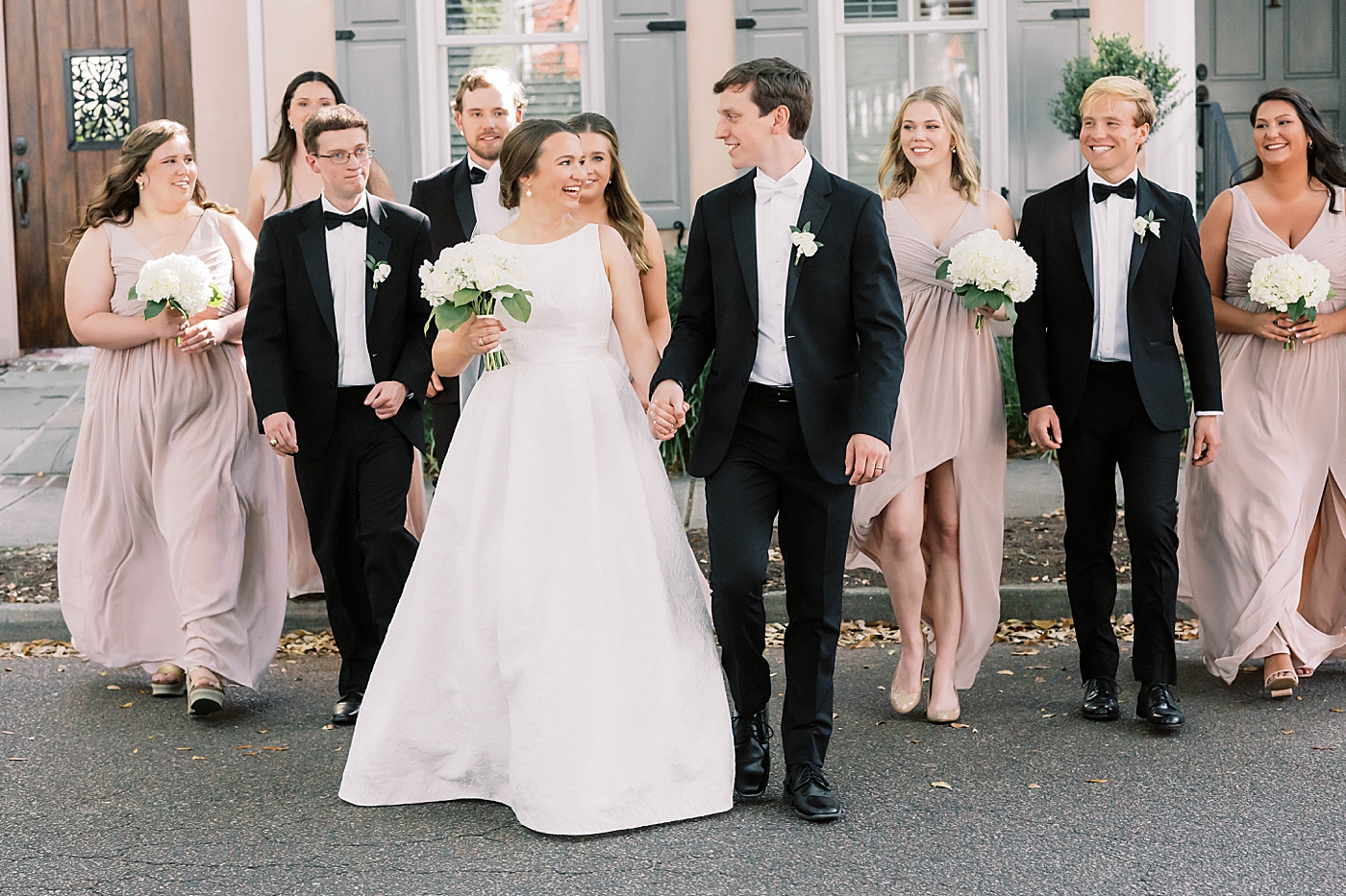 Bride and groom laughing with their bridal party | Carters Event Co
