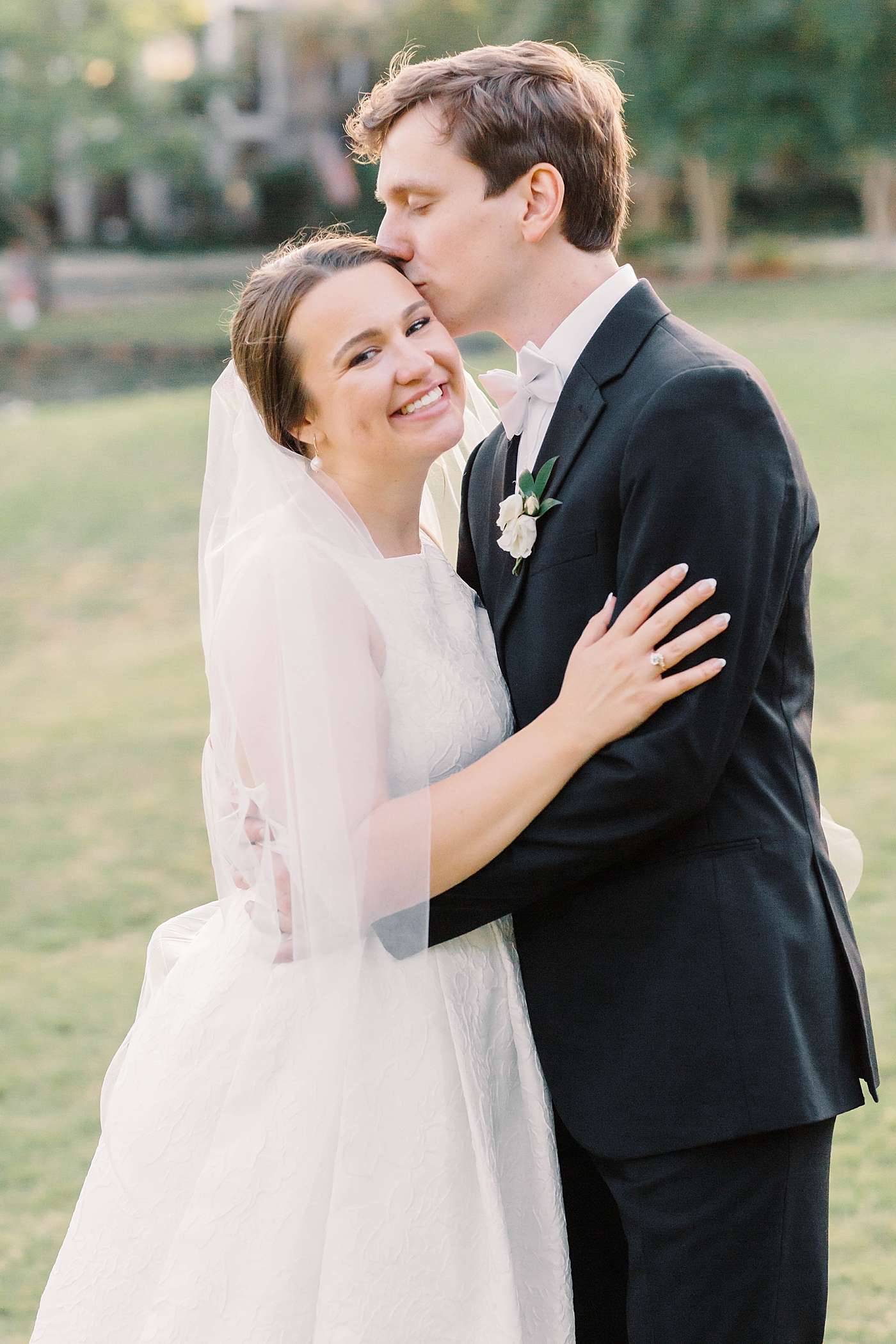 Groom kissing bride during their Intimate spring wedding | Carters Event Co