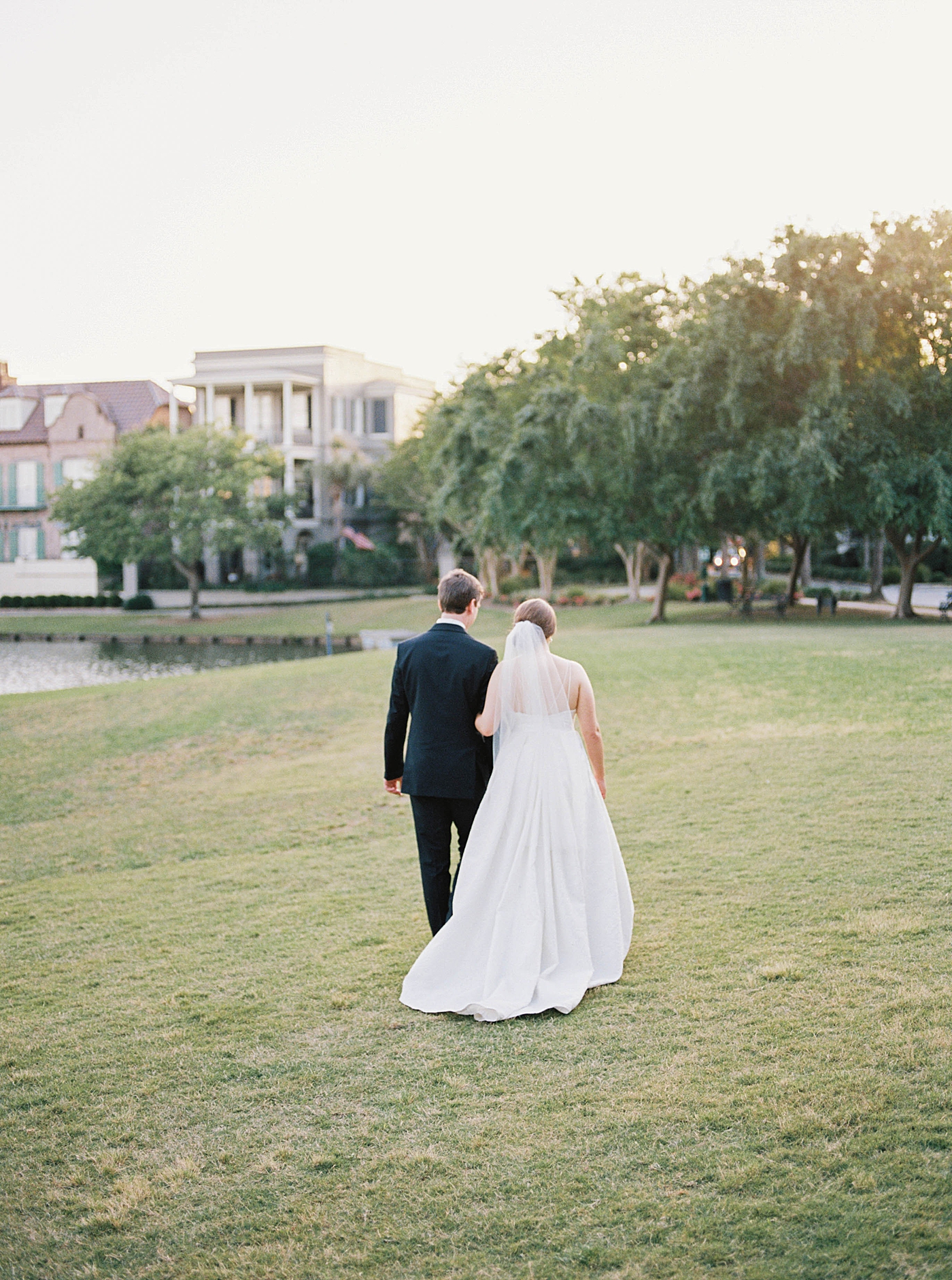 Bride and groom walking near a pond | Carters Event Co