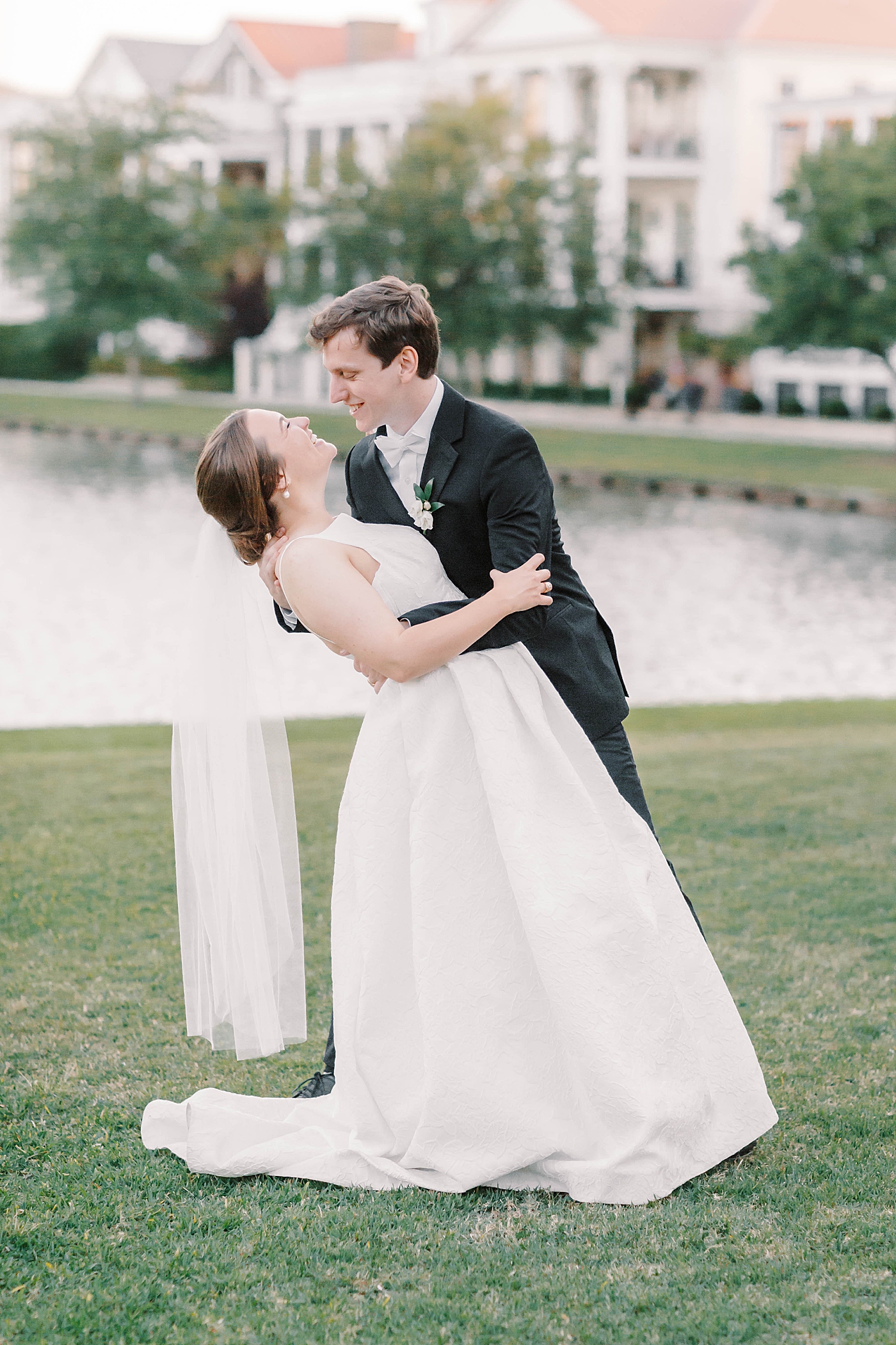 Bride and groom embracing near a pond | Carters Event Co