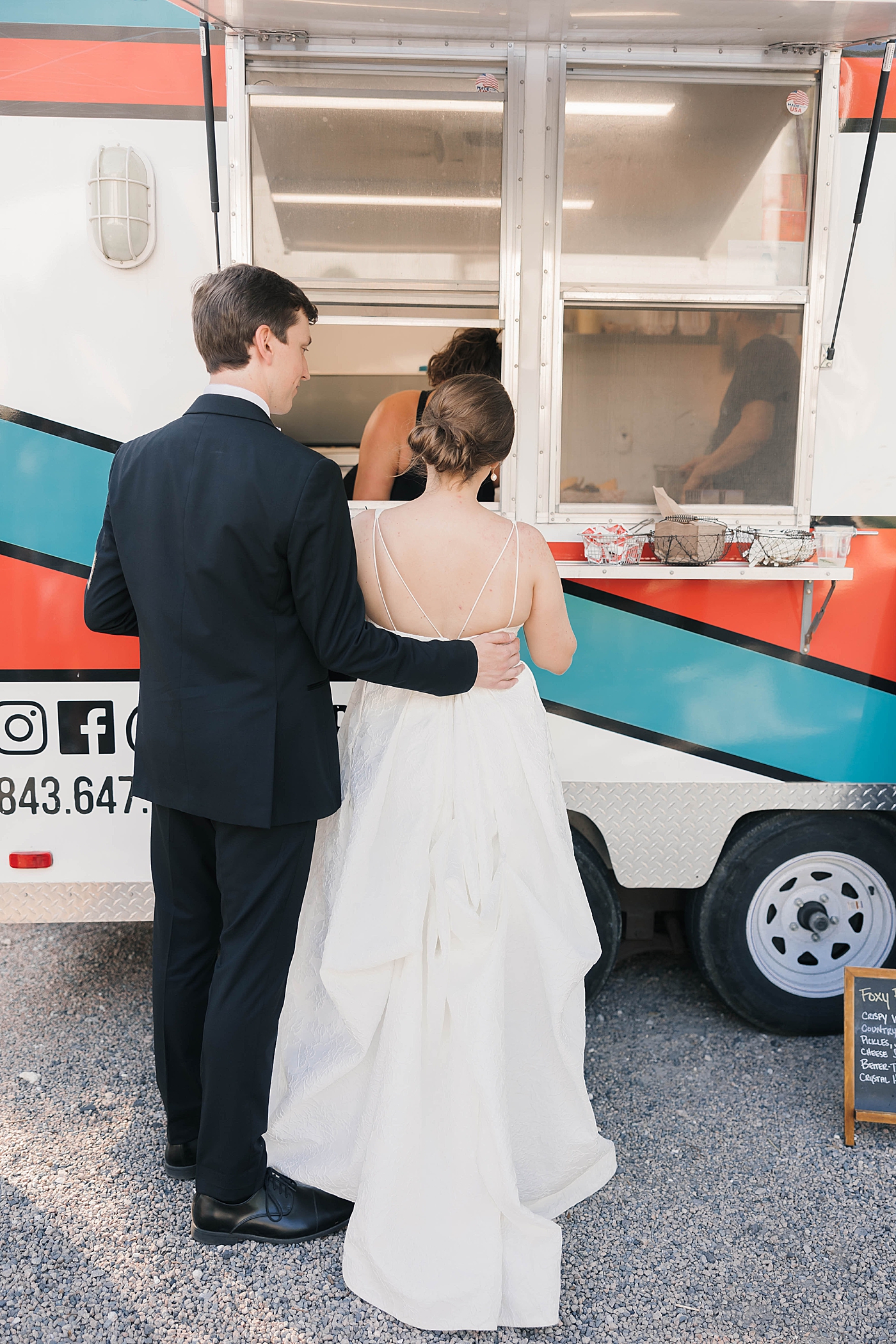 Bride and groom ordering from food truck during their Intimate spring wedding | Carters Event Co
