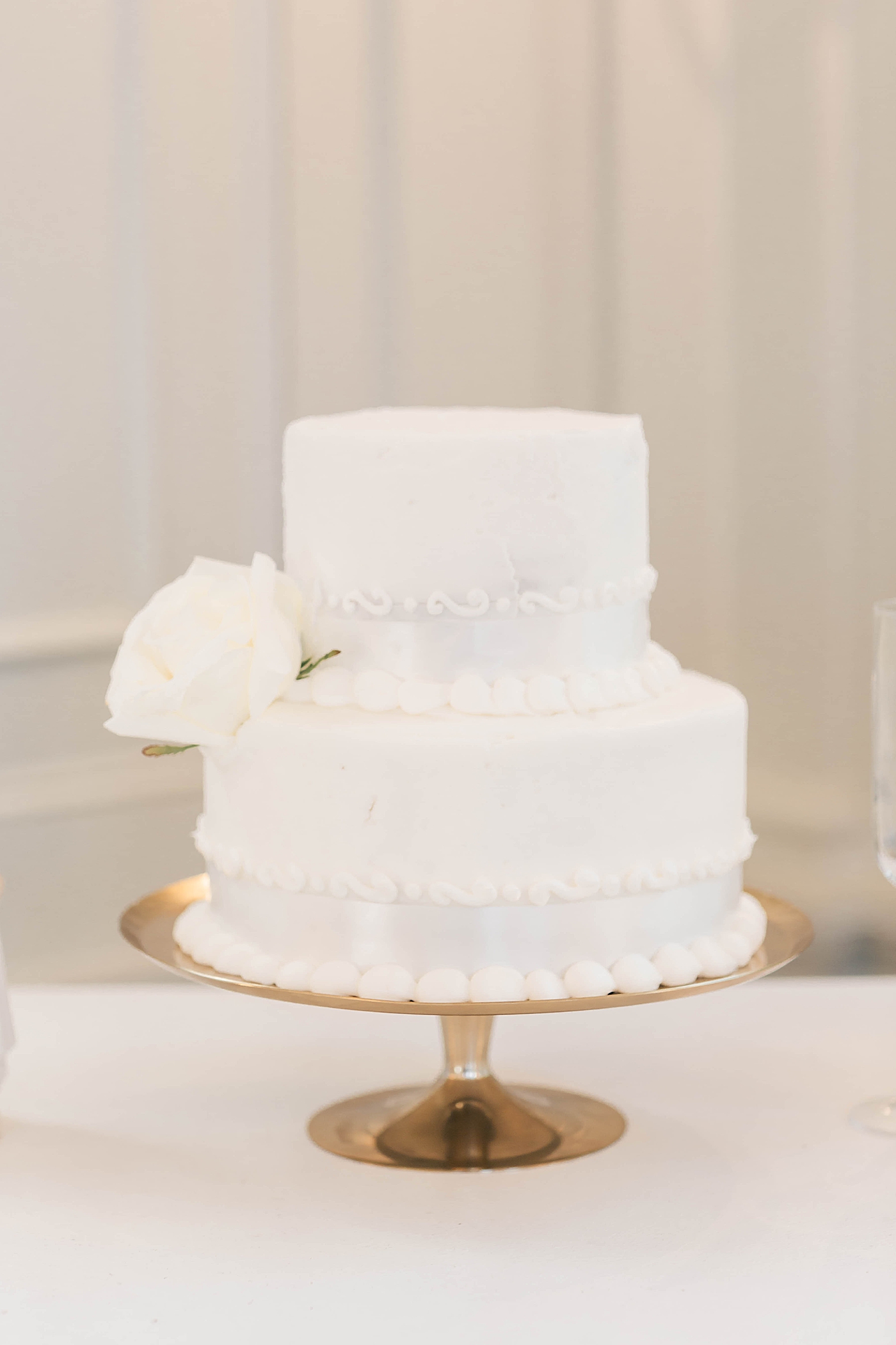 White wedding cake with rose detail during Intimate spring wedding | Carters Event Co